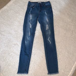 Distressed dark blue jean